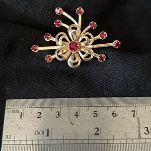 Goldstone and red costume jewelry brooch